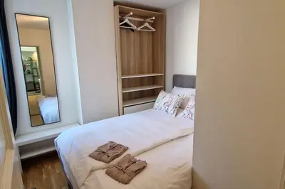 a bedroom with a bed with two towels on it at Central 1 bedroom apartment with a view in Bergen