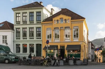 a group of buildings with tables in front of them at Stay l Nordnes in Bergen