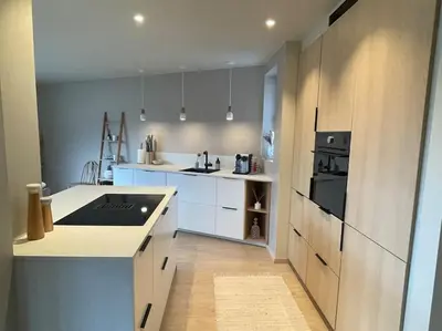 a kitchen with white cabinets and a stove top oven at Apartment in Bergen in Bergen