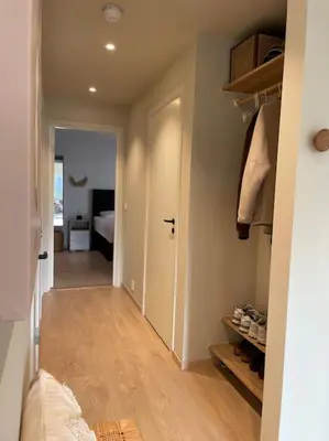a hallway with a room with a door and a bedroom at Apartment in Bergen in Bergen