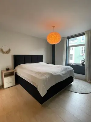 a bedroom with a large bed and a large window at Apartment in Bergen in Bergen