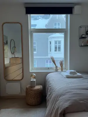 a bedroom with a bed and a large window at Apartment in Bergen in Bergen