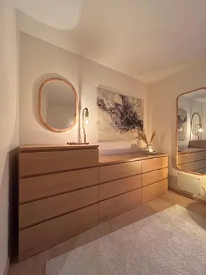 a bathroom with a dresser and two mirrors at Apartment in Bergen in Bergen