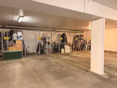 a parking garage with a bunch of cages at Kikut Panorama Geilo Ski-in Ski-out in Geilo