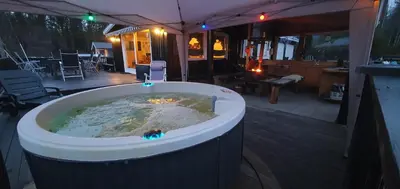 a jacuzzi tub in the middle of a patio at Koselig feriehus med jacuzzi i Nordre Osen, kun 40 minutter fra Trysil skianlegg in Åmot
