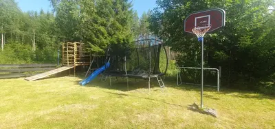 a basketball hoop with a basket in a yard at Koselig feriehus med jacuzzi i Nordre Osen, kun 40 minutter fra Trysil skianlegg in Åmot