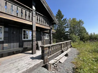 a wooden building with a bench on the side of it at Relaxing Getaway Sauna,Terrace and Pet friendly in Beitostøl