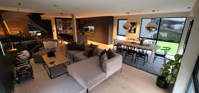 a living room with a white couch and a table at Unique 3-Storey House in Trysil Luxury Living in the Heart of the Village in Trysil