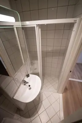 a bathroom with a sink and a shower at Ultra central flat with balcony in Bergen