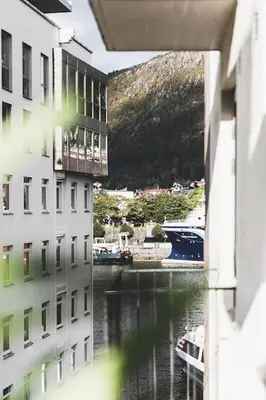 a view of a body of water between two buildings at Ultra central flat with balcony in Bergen