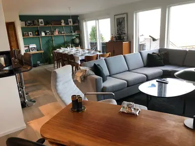 a living room with a couch and a table at Sjarmerende enebolig in Trondheim