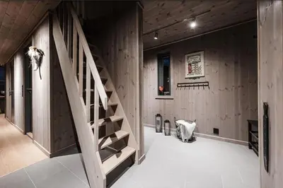 a staircase in a room with wooden walls at Modern cabin with a Mountain View in Nos
