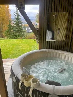 a jacuzzi tub in a room with a window at Bingo apartaments in Hønefoss