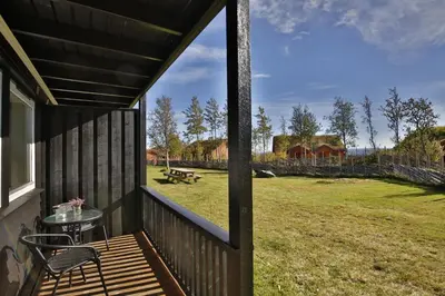 a porch with a table and a view of a field at Ideal Getaway For Couples Or Small Families in Beitostøl