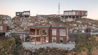 a house on top of a hill with buildings at Runde Panorama - Østen Pilot in Terøy