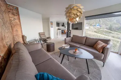 a living room with a couch and a table at Runde Panorama - Østen Pilot in Terøy