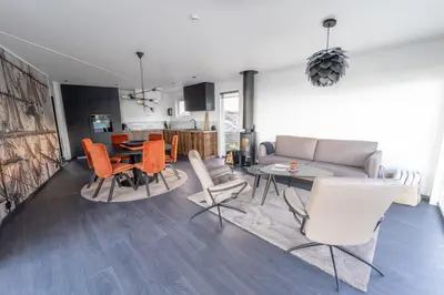a living room with a couch and a table and chairs at Runde Panorama - Castillo in Terøy