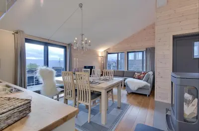 a dining room and living room with a table and chairs at Modern Apartment with 3 Bedrooms and Stunning View in Beitostøl