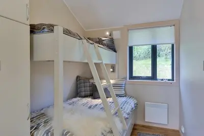 a bunk bed in a room with a ladder at Modern Apartment with 3 Bedrooms and Stunning View in Beitostøl