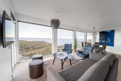 a living room with a couch and a table at Runde Panorama - Blått Hav in Terøy