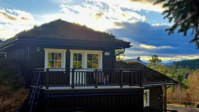 a small house with a porch and a balcony at Stallen in Heggem