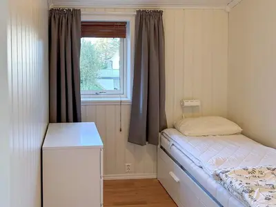 a small bedroom with a bed and a window at 6 person holiday home in HOSTELAND in Hosteland