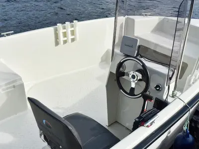 a white boat with a steering wheel and a dashboard at 6 person holiday home in HOSTELAND in Hosteland