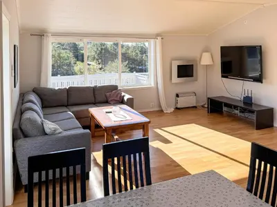 a living room with a couch and a table at 6 person holiday home in HOSTELAND in Hosteland