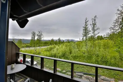 a balcony with a view of a field and trees at Perfect For Skiing And City Access in Beitostøl