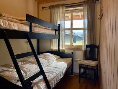 a bedroom with two bunk beds and a window at Perfect For Skiing And City Access in Beitostøl