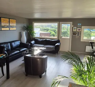 a living room with a couch and a table at Rekkehus med 3 soverom in Trondheim