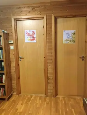 a door in a room with two posters on it at Teglverket in Trondheim
