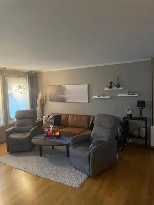 a living room with a couch and two chairs and a table at Ski VM 2025 in Trondheim