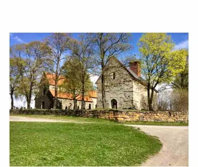 an old stone house with a stone wall and trees at Hytta Kalven in Lunner