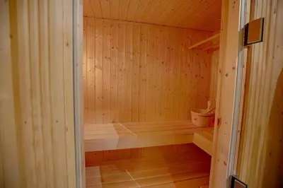 a small wooden sauna with a tub in it at Mountain Escape With Modern Amenities in Beitostøl