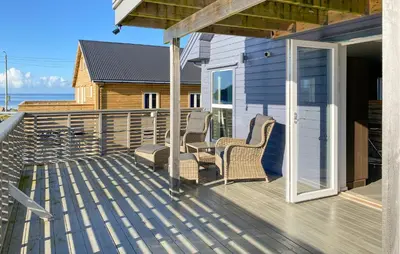 a patio with two chairs and a table on a deck at Beautiful Home In Fjørtoft With Wifi in Fjørtoft