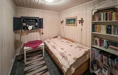 a small room with a bed and a book shelf at Lovely Home In Beitostølen in Beitostøl
