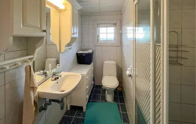 a white bathroom with a sink and a toilet at Lovely Home In Beitostølen in Beitostøl