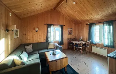 a living room with a couch and a table at Stunning Home In Fåvang With Wifi in Favang