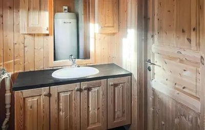 a bathroom with a sink and a mirror at Stunning Home In Fåvang With Wifi in Favang