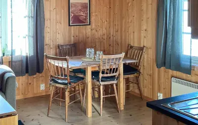 a wooden dining room table with four chairs at Stunning Home In Fåvang With Wifi in Favang
