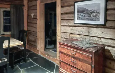 a wooden wall with a dresser in a room at Cozy Home In Fåvang With Wifi in Favang