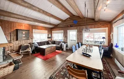 a living room with a large table in a room at Fantastisk Hytte På Lenningen in Etnedal