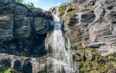 a waterfall on the side of a rocky mountain at 4 Bedroom Stunning Home In Hemsedal in Hemsedal