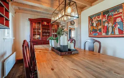a dining room with a table and a painting on the wall at 4 Bedroom Stunning Home In Hemsedal in Hemsedal