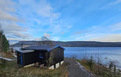 a small shack next to a body of water at 2 Bedroom Awesome Home In Vikersund in Vikersund