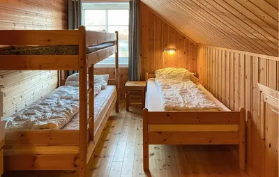 a bedroom with two bunk beds in a cabin at 2 Bedroom Beautiful Home In Frosta