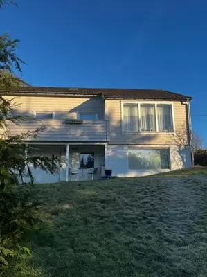 a house with a large yard in front of it at Apartments near Bergen Airport in Bergen