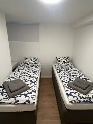 two beds sitting next to each other in a room at Apartments near Bergen Airport in Bergen