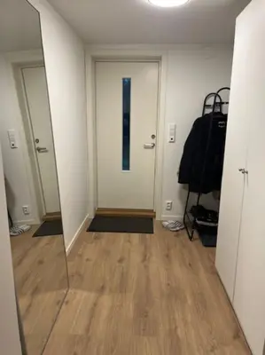 an empty hallway with a mirror and a door at Apartments near Bergen Airport in Bergen